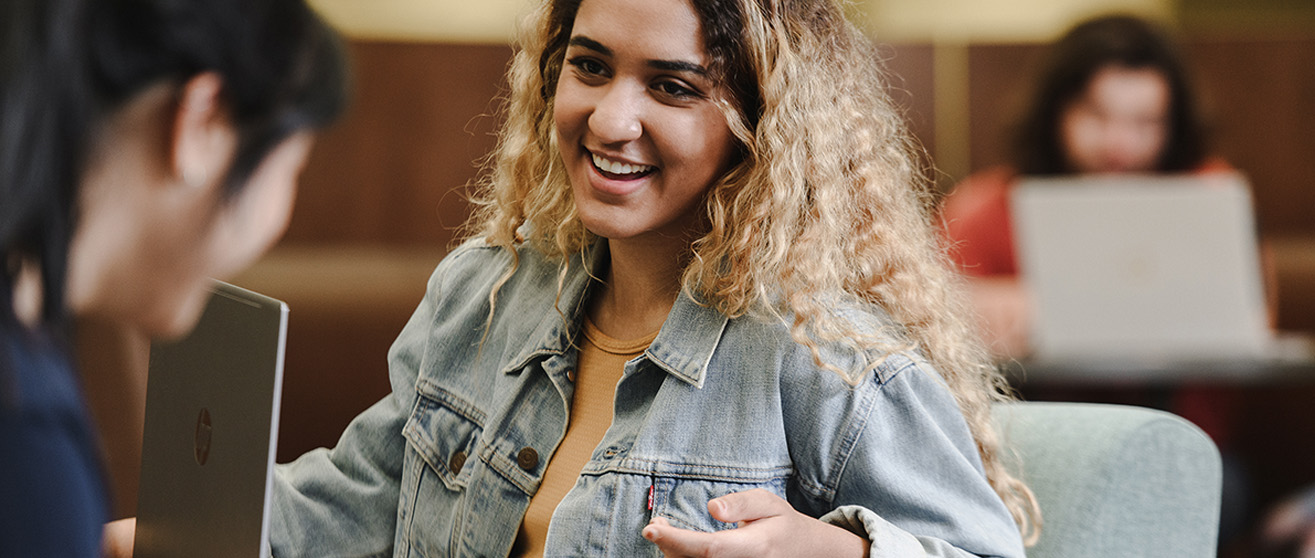 Student smiling in class at the University of Akron