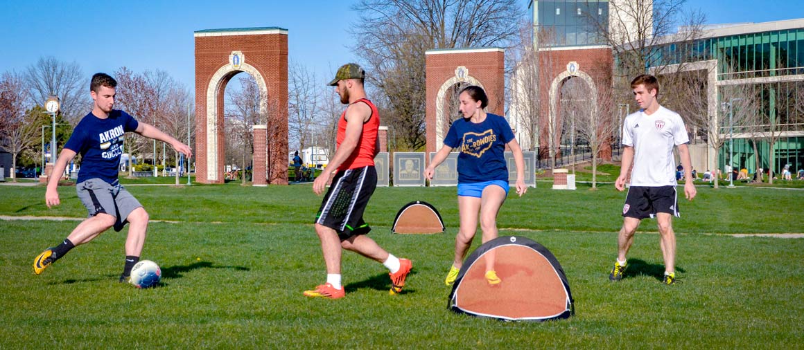 Students playing soccer in a common area on the UA campus.