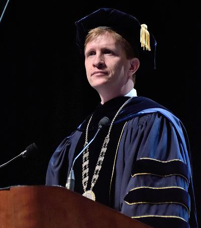 Matt Wilson at podium at commencement